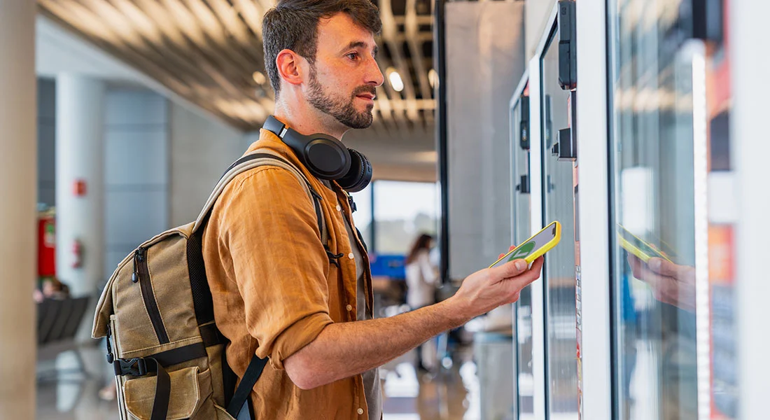 Customer using a modern vending payment terminal